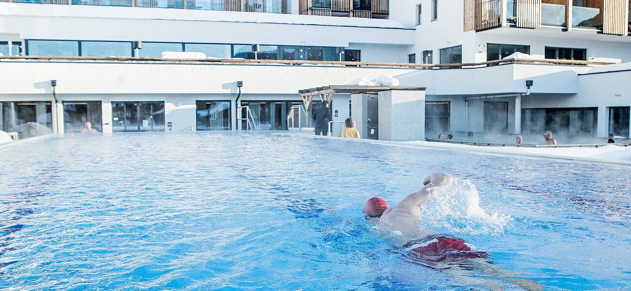 Swimmer in the Outdoor Pool swims a lap